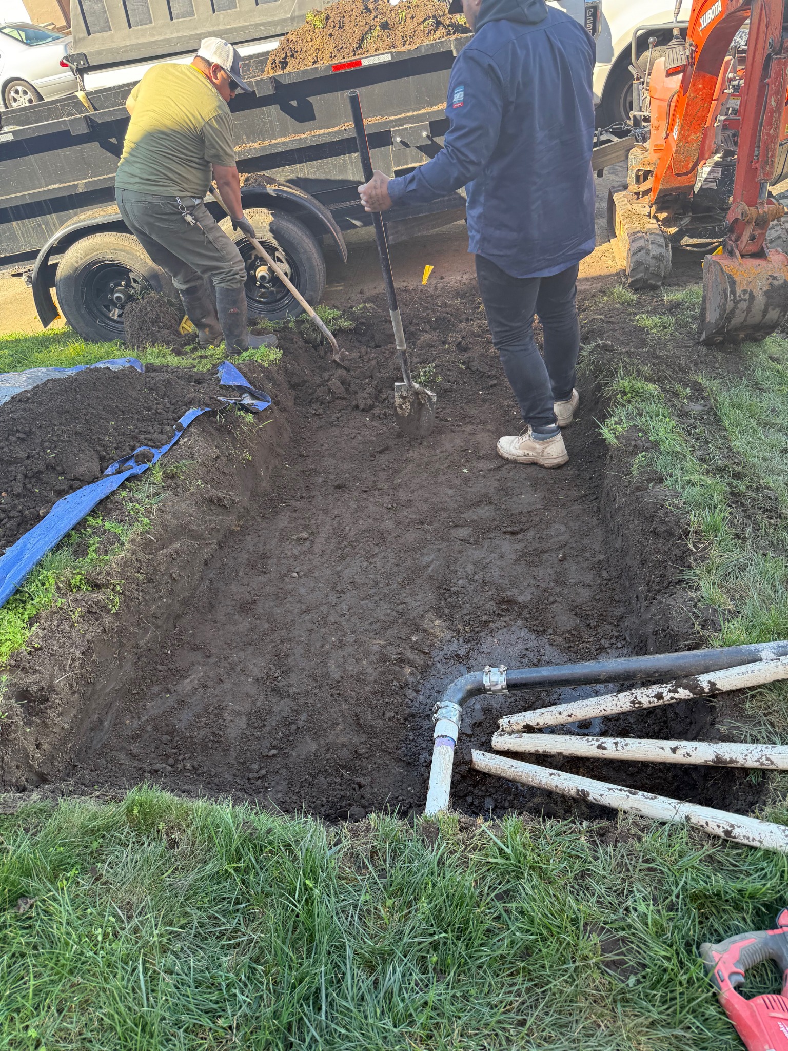 Facilities Plumbing And Drain in the process of digging a drain.