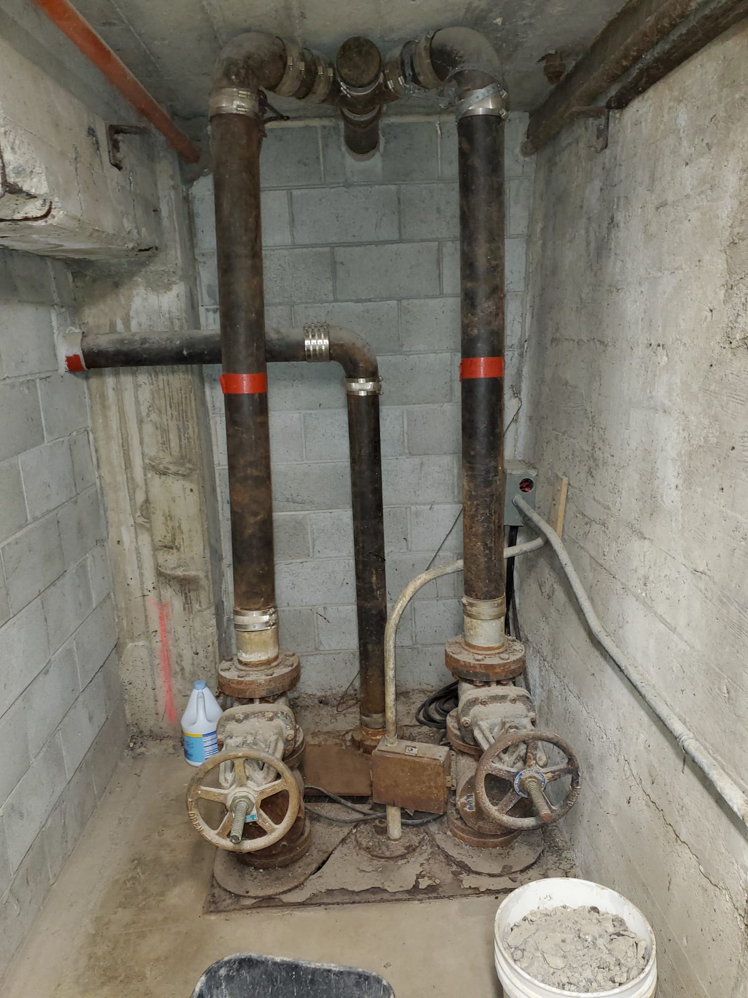 Piping in an underground area during inspection.