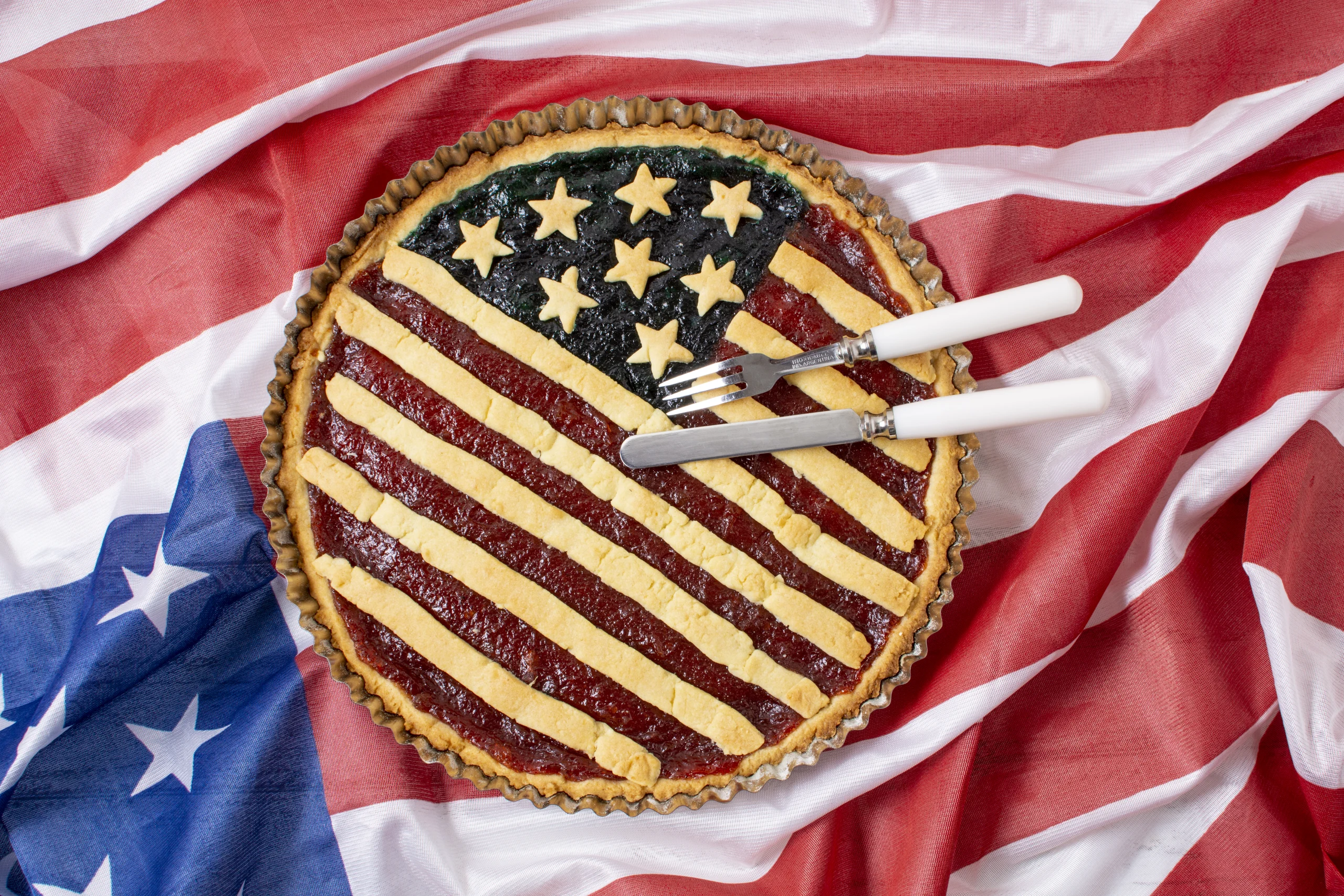 American Made Products Bay Area Facilities Plumbing And Drain A pie decorated like the American flag against an American-flag tablecloth, indicating the high quality of American-made plumbing parts.