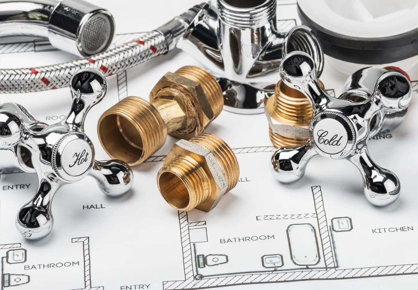 Parts for plumbing repairs on a home's blueprint.